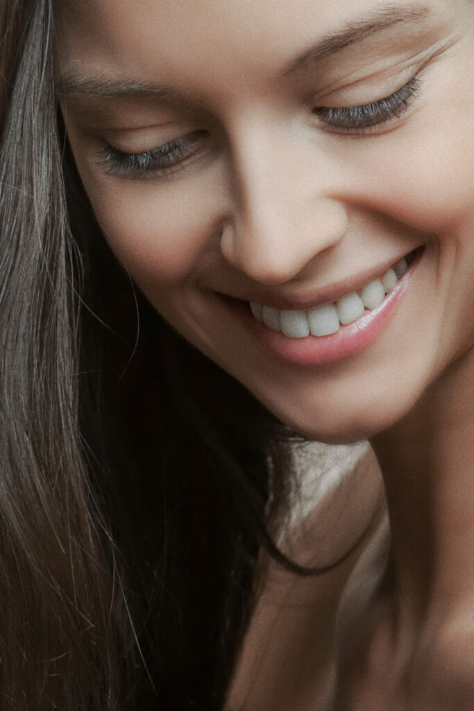 woman smiling with smooth skin following hydrafacial treatment